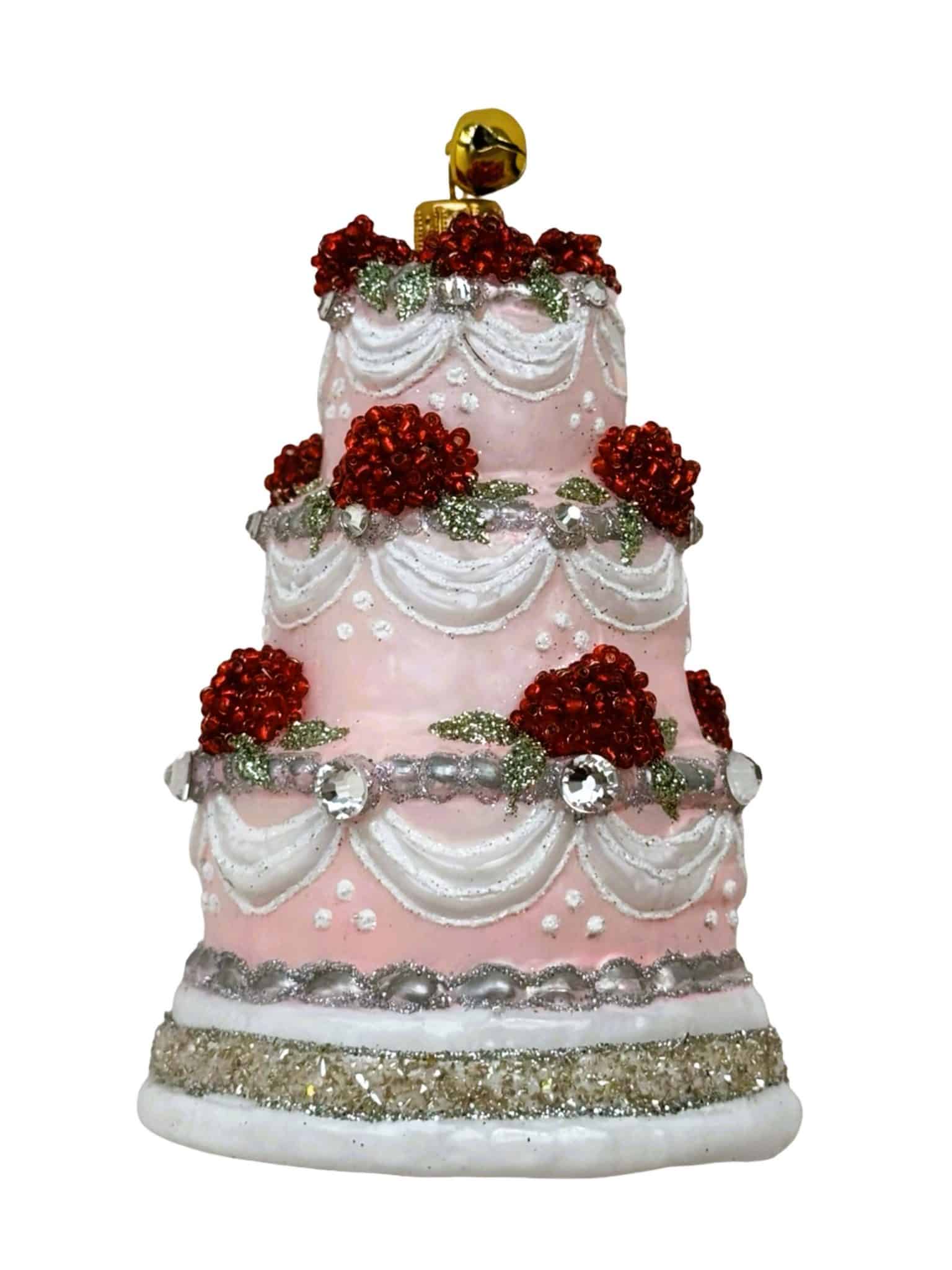 Hand-painted glass three-tier pink Christmas cake ornament with red floral accents and jeweled detailing